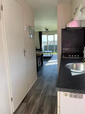 a kitchen with a sink and a counter top at Zee en duin in IJmuiden