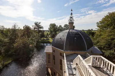 a building with a dome on top of a river at Art+bed and breakfast in 's-Graveland