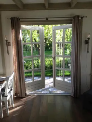 an open door leading to a patio at B&B Saense huisje in Assendelft