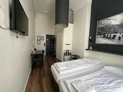 a bedroom with a bed and a flat screen tv at Hotel Hortus in Amsterdam