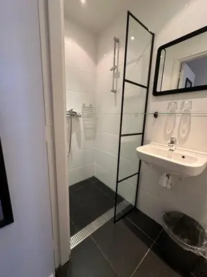 a bathroom with a shower and a sink at Hotel Hortus in Amsterdam