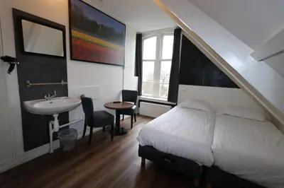 a bedroom with a bed and a sink and a sink at Hotel Hortus in Amsterdam