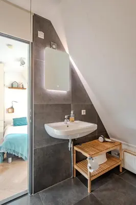a bathroom with a sink and a bed at Perfect Stay Holiday, Sea View in Egmond aan Zee