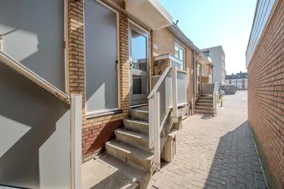 a set of stairs leading to a door on a building at Perfect Stay Holiday, Sea View in Egmond aan Zee