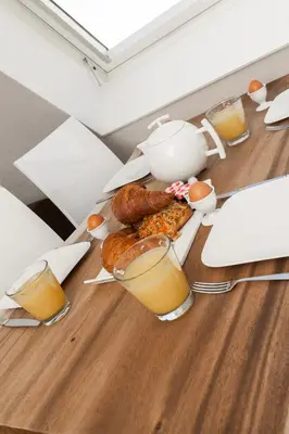 a table with breakfast foods and glasses of orange juice at Perfect Stay Holiday, Sea View in Egmond aan Zee