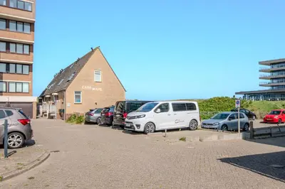 a bunch of cars parked in a parking lot at Perfect Stay Holiday, Sea View in Egmond aan Zee