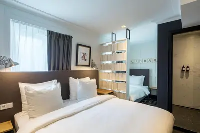 a bedroom with a large bed with white pillows at The Highland House in Amsterdam