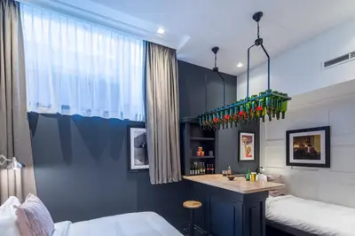 a bedroom with a bar in the corner of the room at The Highland House in Amsterdam