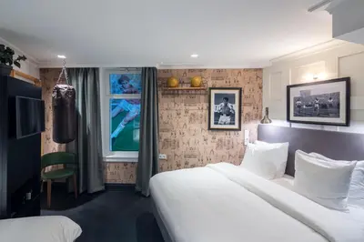 a hotel room with two beds and a television at The Highland House in Amsterdam