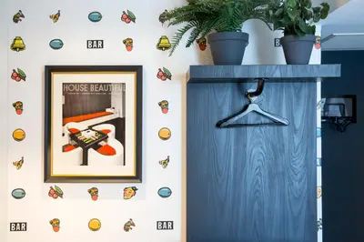 a wall with a picture of a house tenant with butterflies at The Highland House in Amsterdam