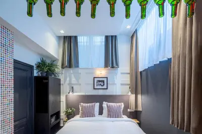 a bedroom with a large bed and windows at The Highland House in Amsterdam