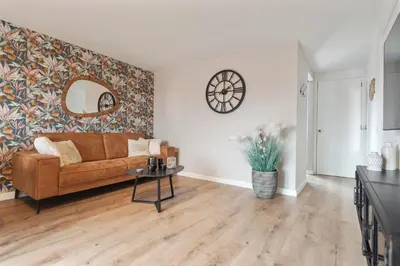 a living room with a couch and a table at The Beach & Town Suite - Free Parking in Zandvoort