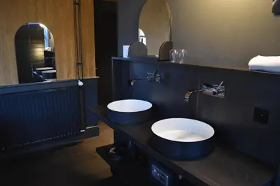 a bathroom with two sinks and a large mirror at Hotel Frank since 1666 in Amsterdam