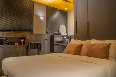 a bedroom with a white bed and a sink at Hotel Frank since 1666 in Amsterdam