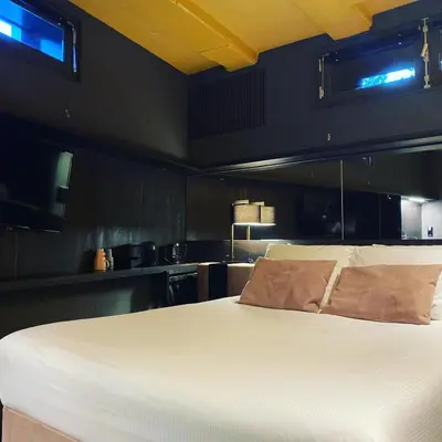 a bedroom with a large white bed in a room at Hotel Frank since 1666 in Amsterdam