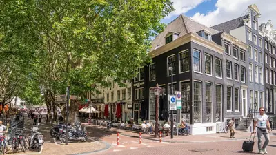a group of buildings on a street in a city at Hotel Frank since 1666 in Amsterdam