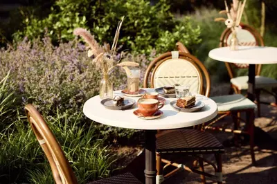 a table with cups and plates of food on it at Van der Valk Hotel Amersfoort-A1 in Amersfoort