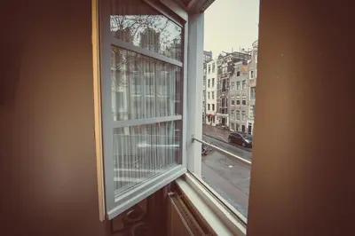 a window with a view of a city street at Tourist Inn One Amsterdam in Amsterdam
