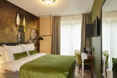 a hotel room with a green bed and a desk at The Muse Amsterdam - Boutique Hotel in Amsterdam