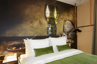 a bedroom with a bed with a lamp on the wall at The Muse Amsterdam - Boutique Hotel in Amsterdam