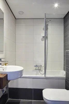 a bathroom with a sink and a shower and a toilet at The Muse Amsterdam - Boutique Hotel in Amsterdam