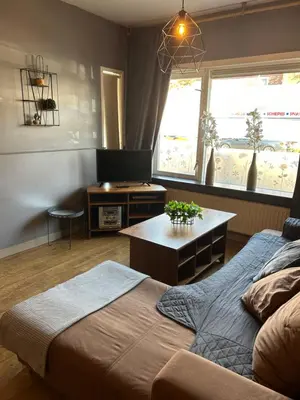a bedroom with a bed and a table and a television at Hotel Velsen in IJmuiden