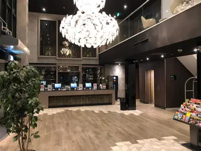 a store with two chandeliers and a counter at Hotel Levell in Amsterdam