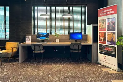 an office with a desk with a computer and two chairs at Hotel Levell in Amsterdam