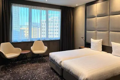 a hotel room with a bed and two chairs at Hotel Levell in Amsterdam