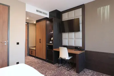 a hotel room with a desk and a bed at Hotel Levell in Amsterdam