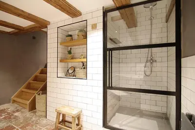 a bathroom with a shower with a glass door at Authentic Farmhouse - De Vergulden Eenhoorn in Amsterdam