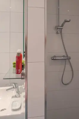 a bathroom with a shower and a sink at Studio South Beach with garden and free parking in Zandvoort