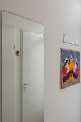 a glass door with a picture hanging on the wall at Studio South Beach with garden and free parking in Zandvoort