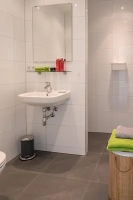 a bathroom with a sink and a toilet at Studio South Beach with garden and free parking in Zandvoort