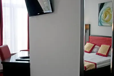 a room with a bed and a desk with a desk at Hotel Allure in Amsterdam