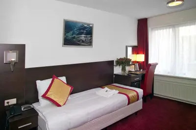 a hotel room with a bed and a desk at Hotel Allure in Amsterdam