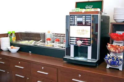 a coffee shop with a ice shop machine on a counter at Hotel Allure in Amsterdam