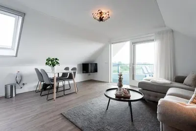 a living room with a couch and a table at Chez Marly in Oosterblokker