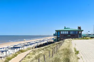 a building on the beach next to the ocean at Beachhouse Hotel in Zandvoort