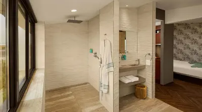 a bathroom with a shower and a sink at Beachhouse Hotel in Zandvoort