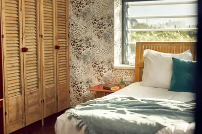 a bedroom with a bed and a window at Beachhouse Hotel in Zandvoort