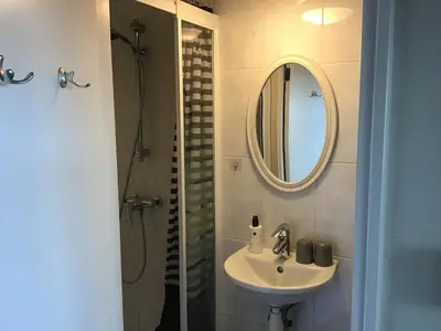 a bathroom with a sink and a mirror at Life@Sea in Zandvoort