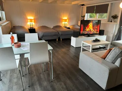 a living room with a couch and a tv at Boathouse Amsterdam with bikes in Amsterdam