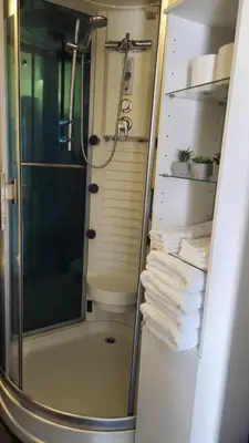 a shower in a bathroom with a glass shower stall at Boathouse Amsterdam with bikes in Amsterdam