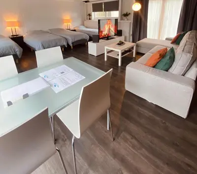 a living room with a table and a couch at Boathouse Amsterdam with bikes in Amsterdam
