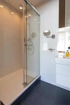 a shower with a glass door in a bathroom at Hotel La Rosa Amsterdam Beach in Zandvoort