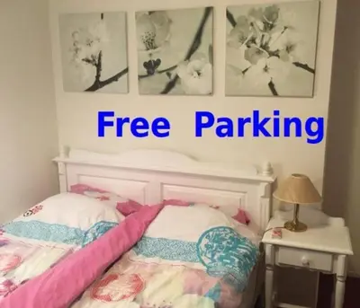 a bedroom with a free parking sign above a bed at Wim's Place Schiphol Amsterdam Airport in Hoofddorp