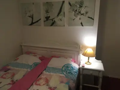 a bedroom with a bed and a table with a lamp at Wim's Place Schiphol Amsterdam Airport in Hoofddorp