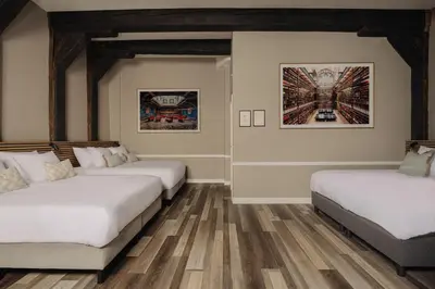 two beds in a room with wooden floors at Adam's Canal House in Amsterdam