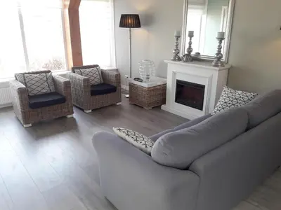 a living room with a couch and chairs and a fireplace at Vecht & Weide Weesp in Weesp